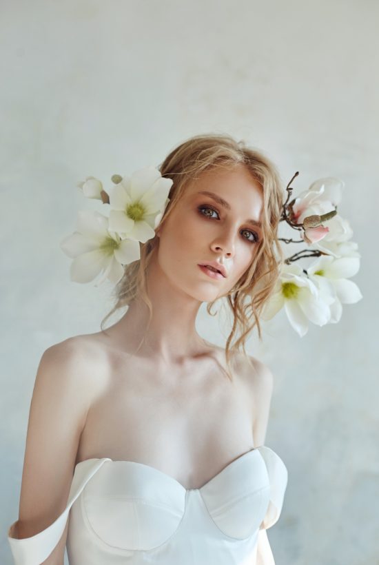 beautiful-slender-blonde-evening-sun-long-white-dress-portrait-woman-with-flower-perfect-hairstyle-cosmetics-bride