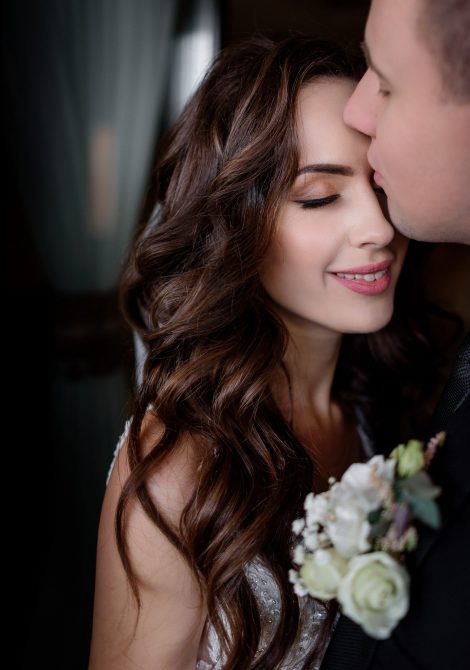 Portrait of bride and groom madly in love with closed eyes, wedding day, wedding photo